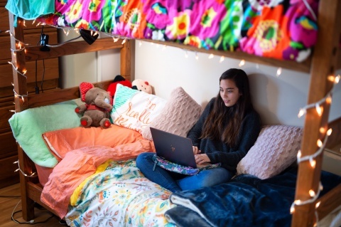 Student using laptop in dorm room