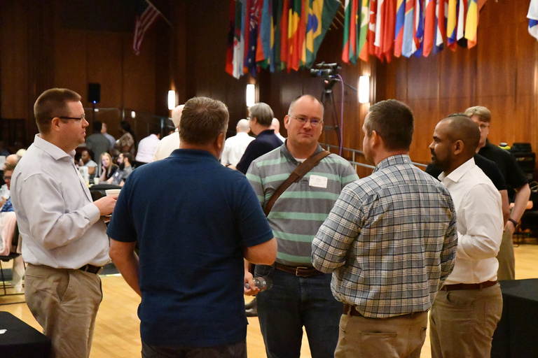Tech Forum attendees conversing during a break in sessions
