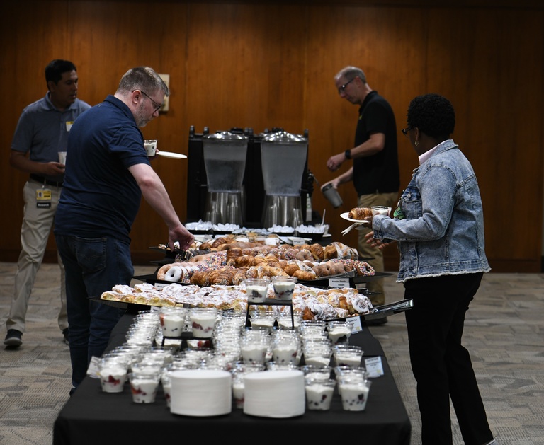 Tech Forum attendees visit the complementary breakfast station during registration