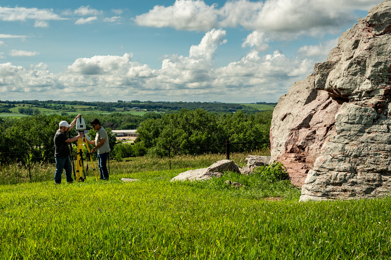 Two workers using scanners to digitally preserve Pilot Rock