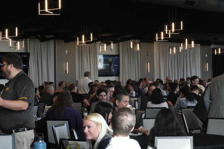 Tech Forum attendees finding a seat in event center