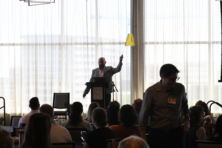 Emcee, Dave Long, pumps up the crowd with Tech Forum chant