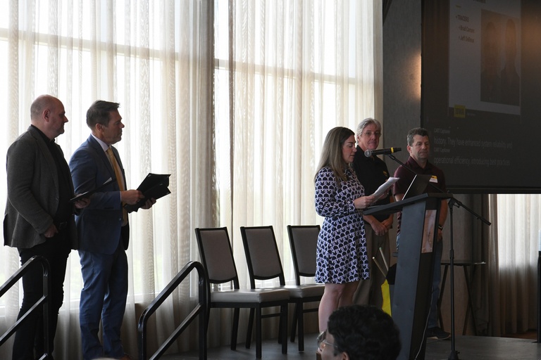 Katie Kahler, Brad Rohrer, and Josh Wilda present the IT Leadership Team Achievement Award to Brad Carson and Jeff DeReus.