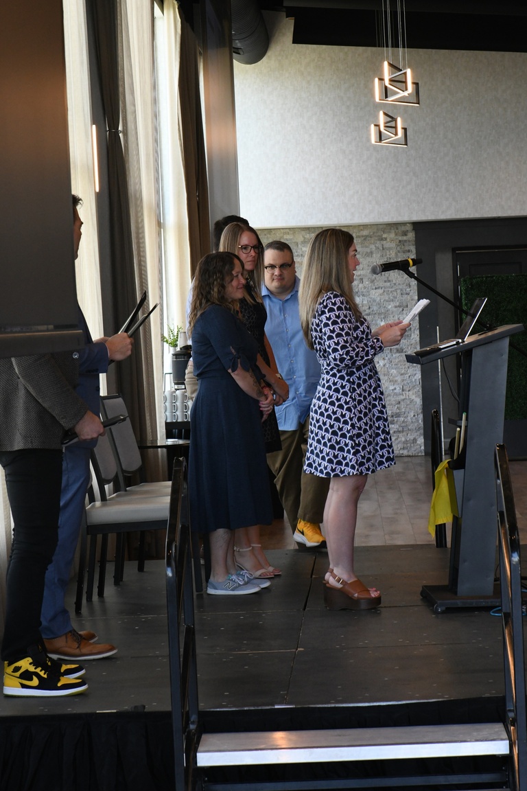 Katie Kahler, Brad Rohrer, and Josh Wilda present the IT Leadership Team Achievement Award to the Halo team. 