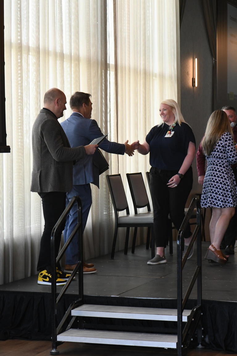 Katie Kahler, Brad Rohrer, and Josh Wilda present the IT Leadership Community Engagement Award to Kandis Schmitz, admin services manager for HCIS Telecommunications.