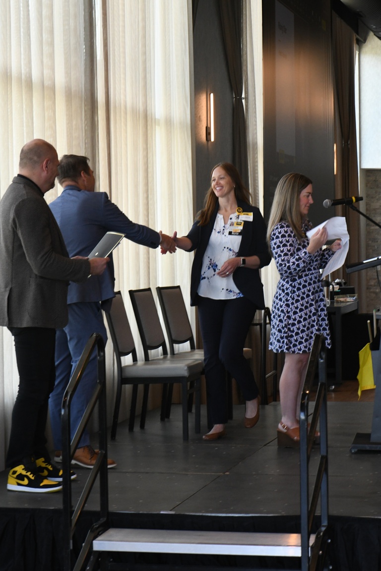 Katie Kahler, Brad Rohrer, and Josh Wilda present the IT Leadership Rising Star Award to Beth Schmidt, assistant director of HCIS Clinical Informatics.